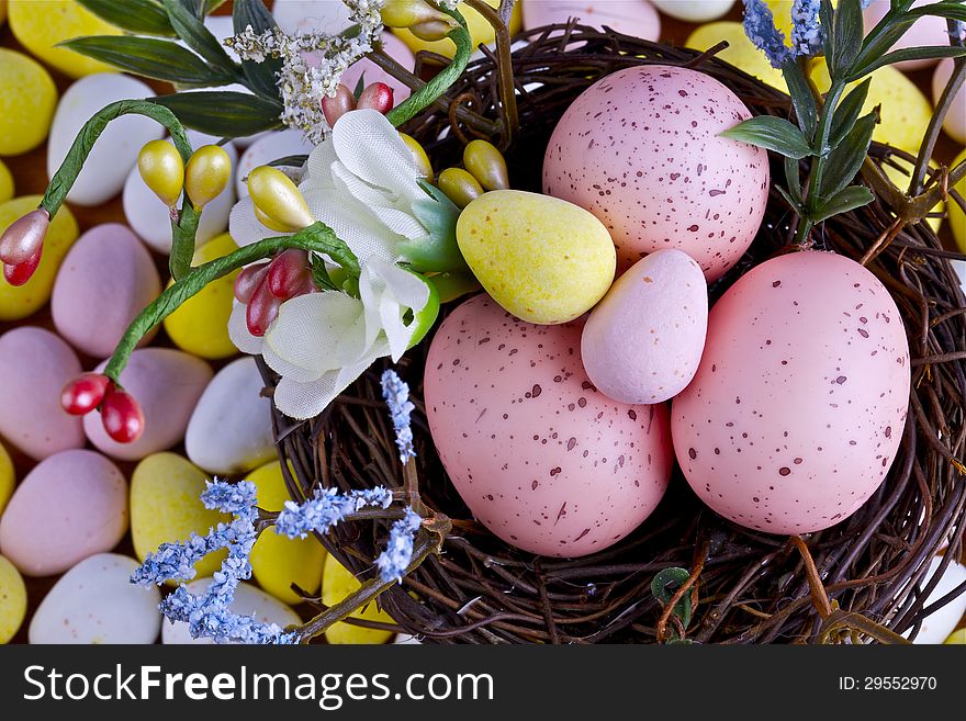 Easter eggs in nest and candy with decoration. Easter eggs in nest and candy with decoration.
