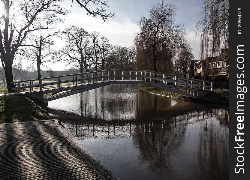 A bridge, over clear water, on a sunny winterday. A bridge, over clear water, on a sunny winterday.