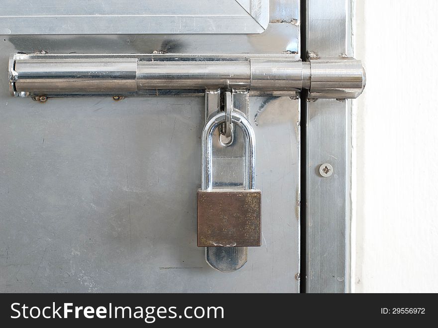 old latch with padlock on doors .