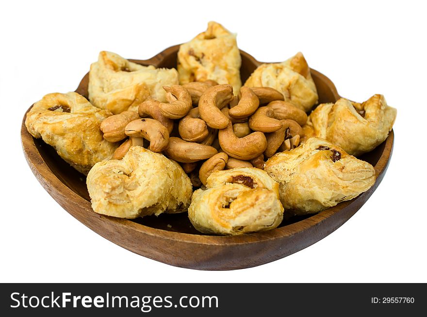 Pineapple puff and roasted cashew nuts isolated on white background.