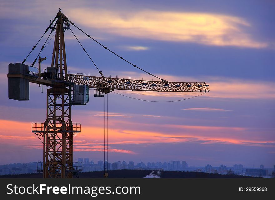 Building crane on sky background at sunset. Building crane on sky background at sunset.