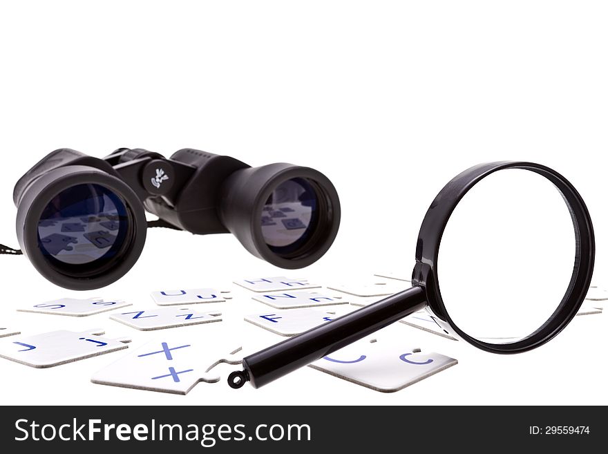 Binoculars, puzzle pieces and magnifier isolated on white. Binoculars, puzzle pieces and magnifier isolated on white.