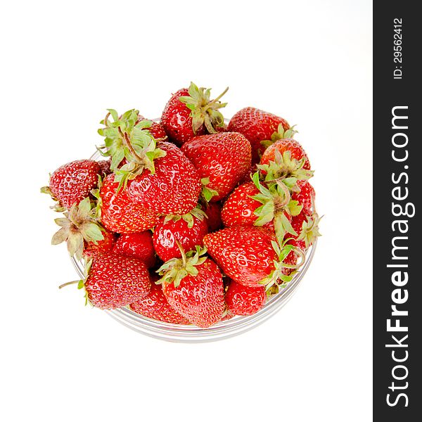 Plate with strawberries view from the top on a white background