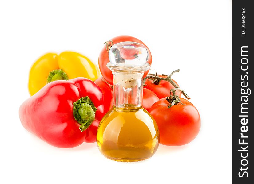 Bottle with olive oil ,tomatoes and peppers on a white background