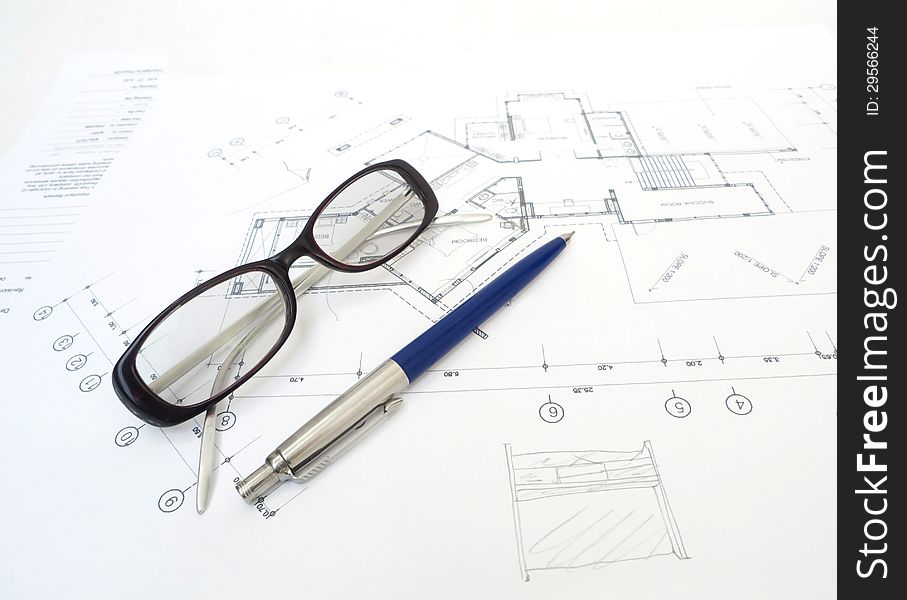 Glasses and a pencil on top of architecture blueprints. Glasses and a pencil on top of architecture blueprints.