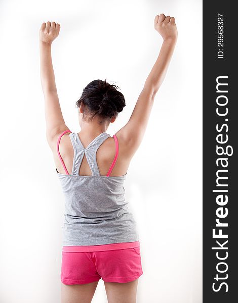 Back view of a indian modern girl raising up her arms against white. Back view of a indian modern girl raising up her arms against white