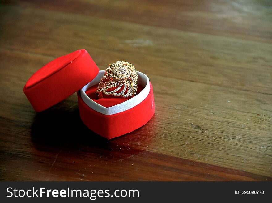 Close up  wedding rings in a red box on a wooden table