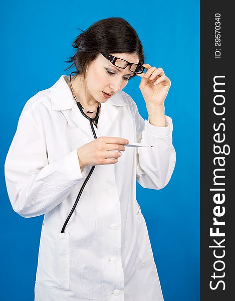 Female doctor holding a thermometer. Female doctor holding a thermometer