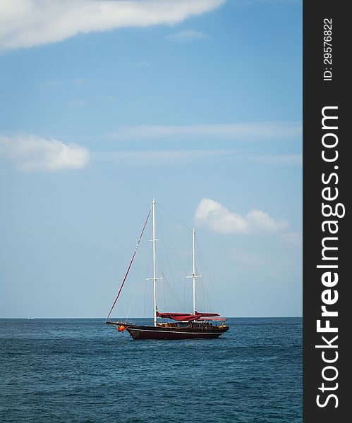 A sailboat floating at andaman sea with blue sky. A sailboat floating at andaman sea with blue sky