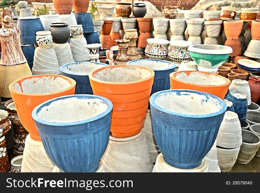 Many different colorful flower pots in workshop. Many different colorful flower pots in workshop.