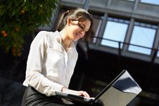 Attractive Young Businesswoman Typing In A Laptop Computer, Urba Stock Photography