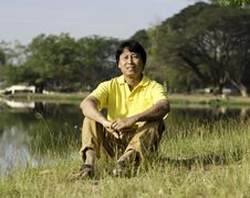 Asian Man Sitting  In The Park Royalty Free Stock Photo