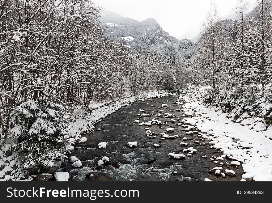 A winter landscape with river and mountain in the background. A winter landscape with river and mountain in the background