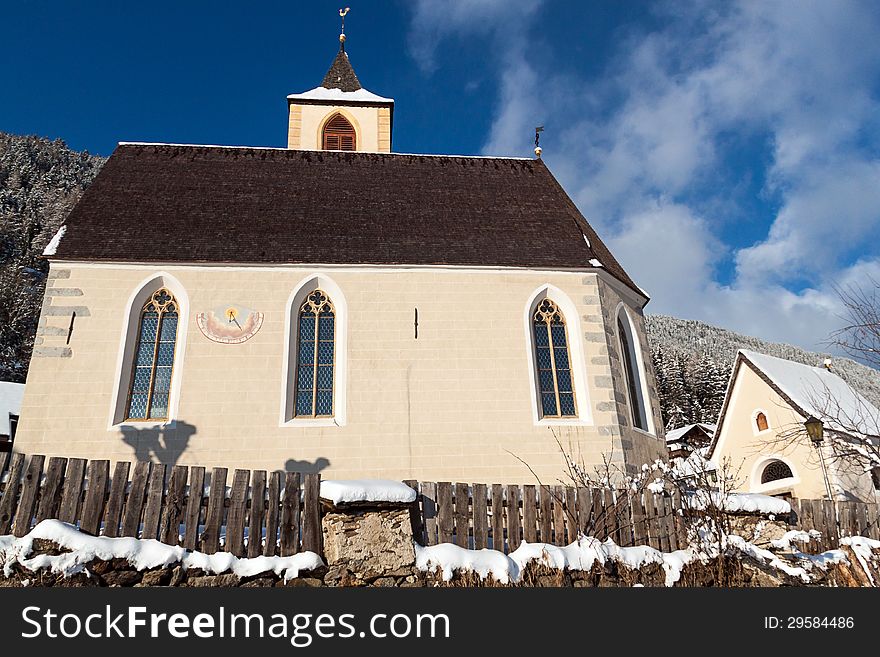 A Wintertime View Of A Small Church With A Tall Steeple