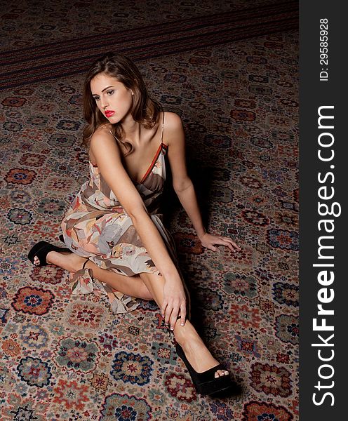 Beautiful teen model sitting on rug. Beautiful teen model sitting on rug