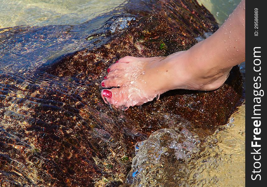 Woman&#x27;s foot in the water