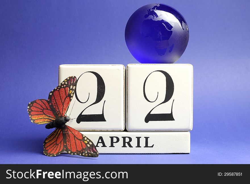 Earth Day, save the date white block calendar, April 22, with butterfly and globe against a blue background. Earth Day, save the date white block calendar, April 22, with butterfly and globe against a blue background.