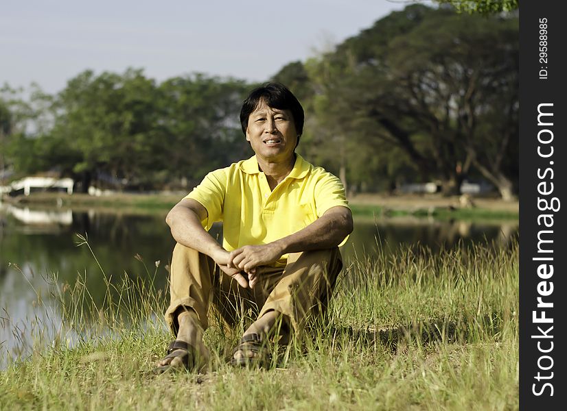 Asian man sitting  in the park