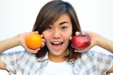 Beautiful Asian Teenage Holding Orange And Apple Fruits Near Smi Stock Images