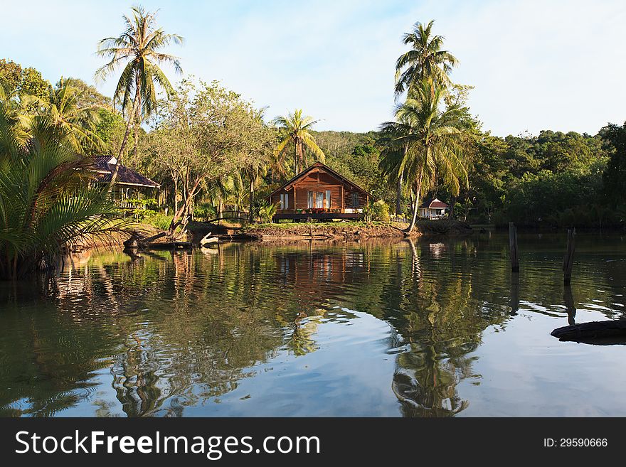 Wooden cottage on the waterfront of the tropical jungle. Wooden cottage on the waterfront of the tropical jungle