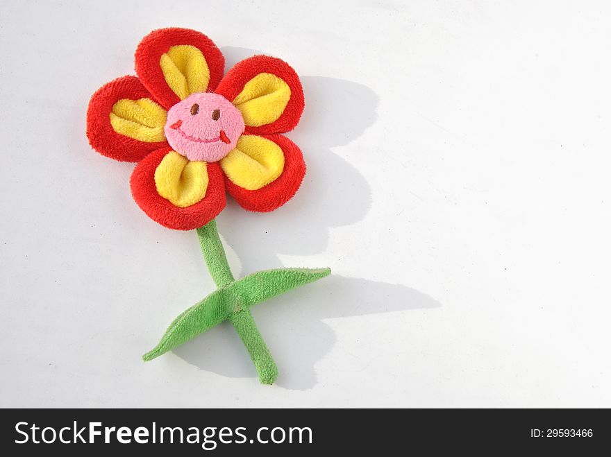 Plush smiling flower with shadow on white background. Plush smiling flower with shadow on white background