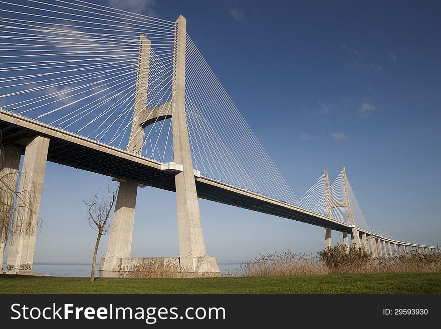 View of Vasco da Gama bridge above Tagus (Tejo) river in Lisbon in a sunny January day around sunset