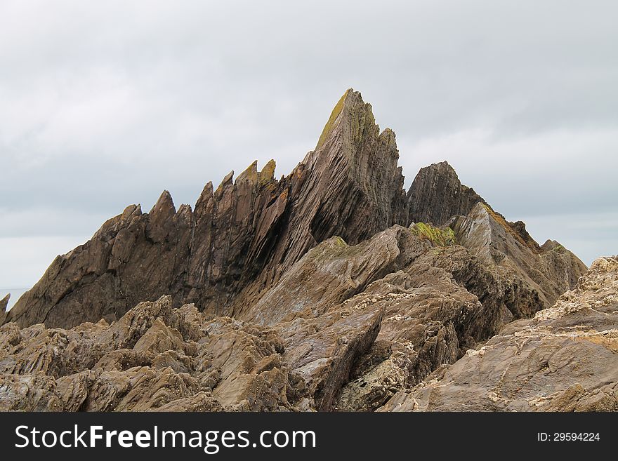 Dramatic Rock Formations on a Coastal Cliff. Dramatic Rock Formations on a Coastal Cliff.