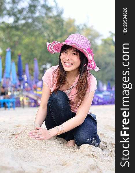 Beautiful asian woman relaxation on beach with hat