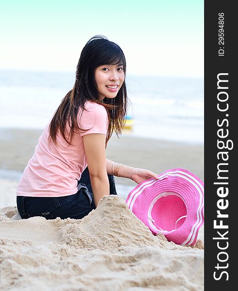 Asian Woman Relaxation On Beach With Hat