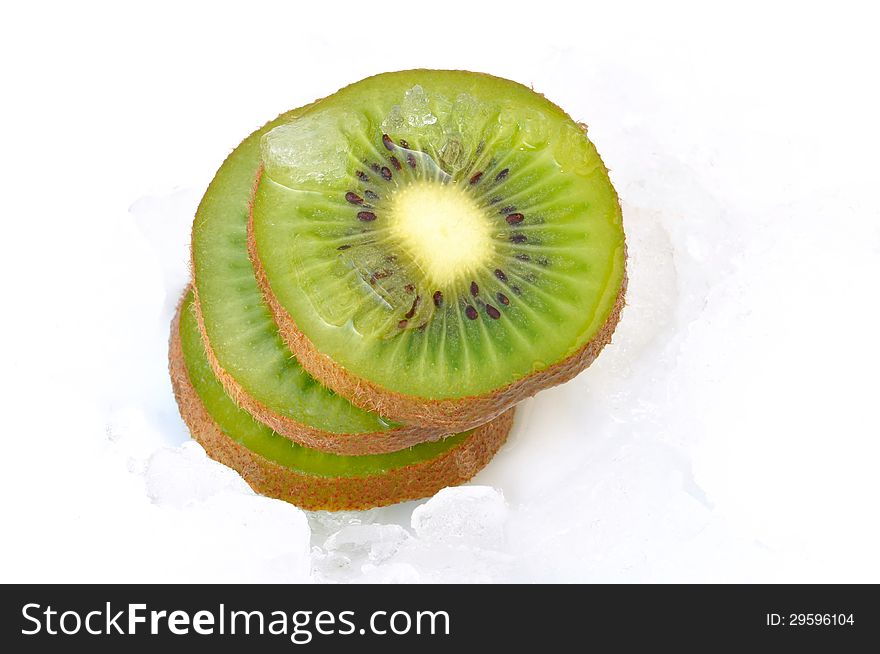 Kiwi slices stacked on ice on white background. Kiwi slices stacked on ice on white background