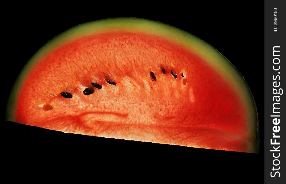 A backlit slice of a melon