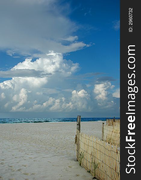 Late afternoon view of beach front with wood barrier. Late afternoon view of beach front with wood barrier