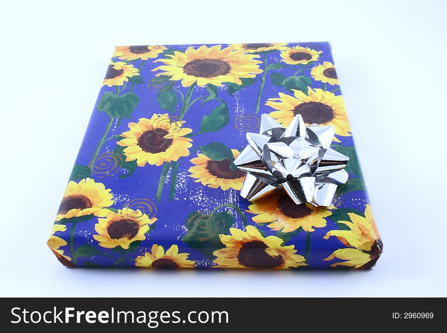 Gift with some sunflower wrapping and a rosette. Gift with some sunflower wrapping and a rosette