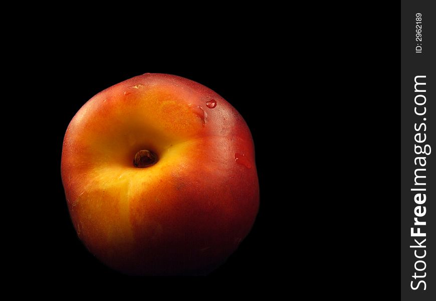 Ripe nectarine with water drops