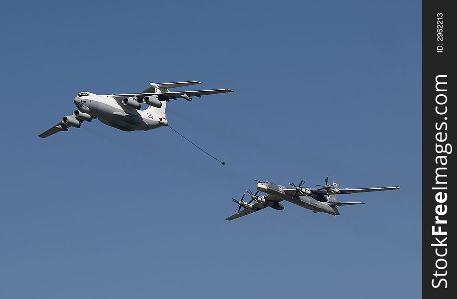 The distant Russian bomber refuels in air. The distant Russian bomber refuels in air