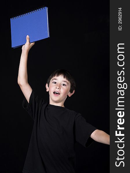 Boy posing for back to school theme over black background