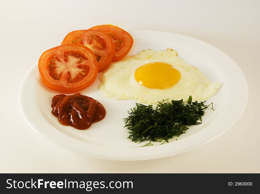 Morning breakfast with tomatoes, ketchup, dill and egg