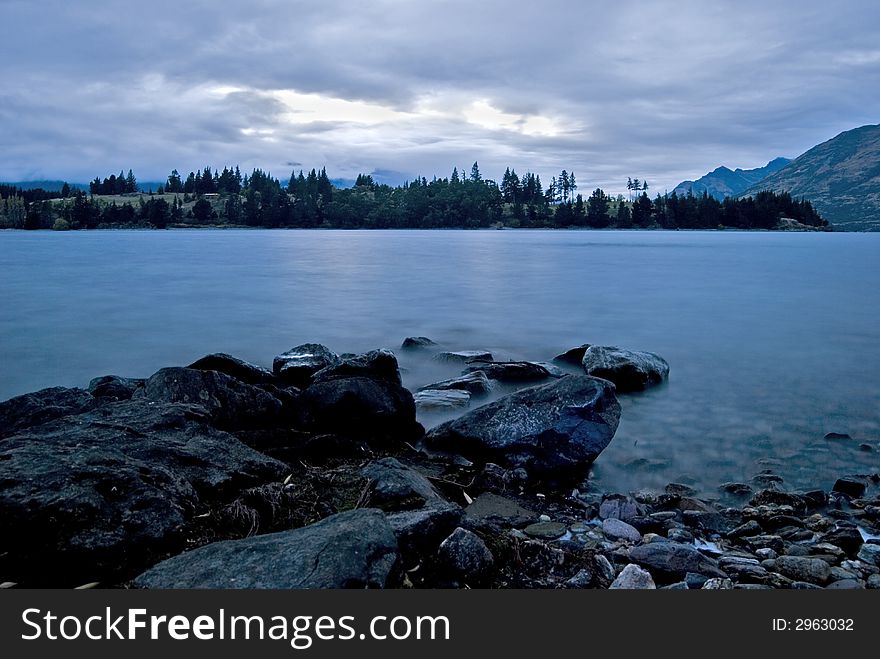 Lake Wakatipu shoreline shot at sunrise. Lake Wakatipu shoreline shot at sunrise