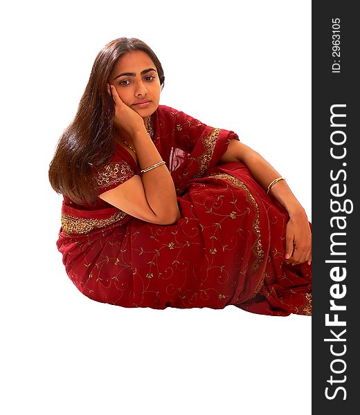 An beautiful Indian lady in her native dress sitting on the floor and the camera from above, on white background. An beautiful Indian lady in her native dress sitting on the floor and the camera from above, on white background.