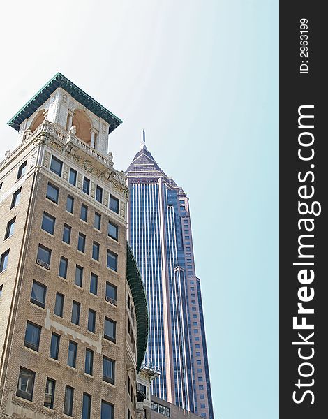 A modern skyscraper with a classic office tower in the foreground. A modern skyscraper with a classic office tower in the foreground