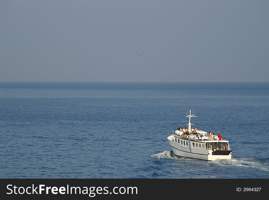 A small motorized boat in a sea - tourists carrier. A small motorized boat in a sea - tourists carrier