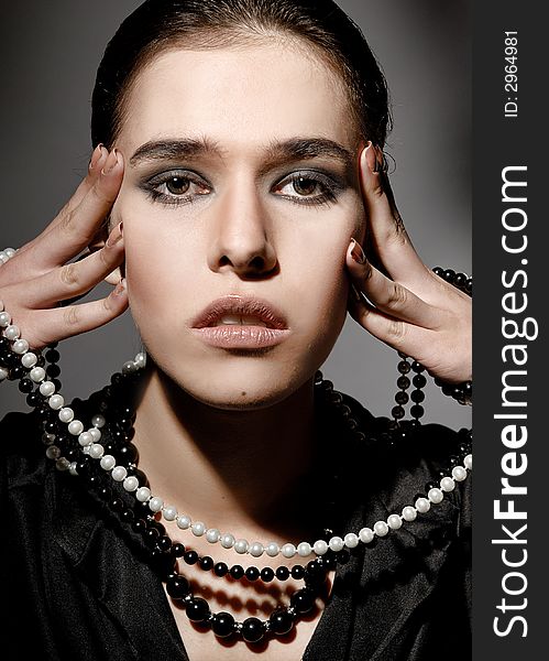 Brunette woman with white and black beads. Brunette woman with white and black beads