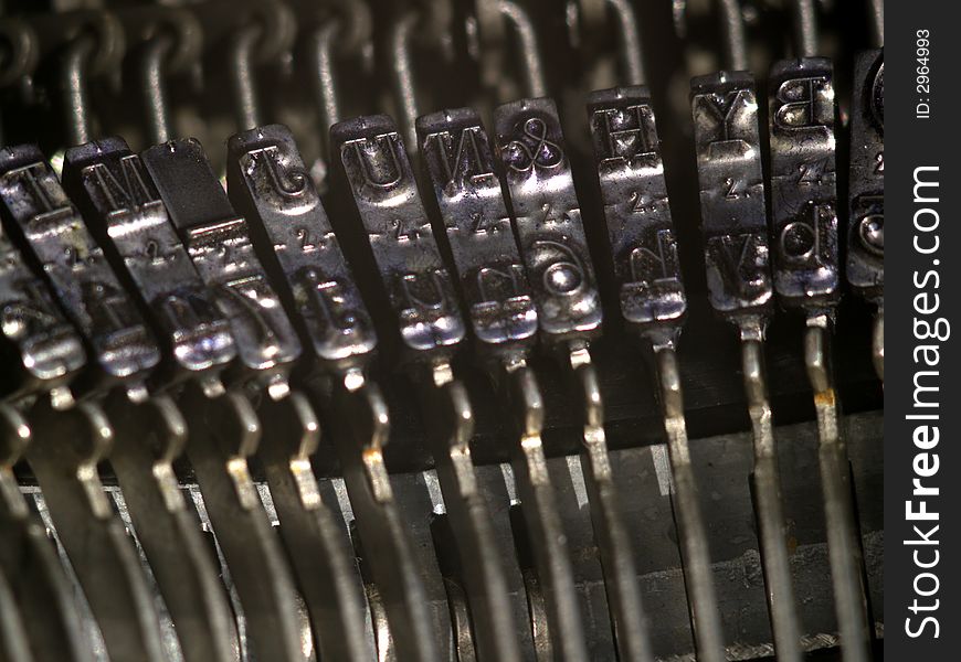 Closeup of typebars on a vintage typewriter