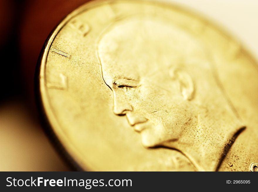 Close-up of gold one dollar coin and pen. Close-up of gold one dollar coin and pen