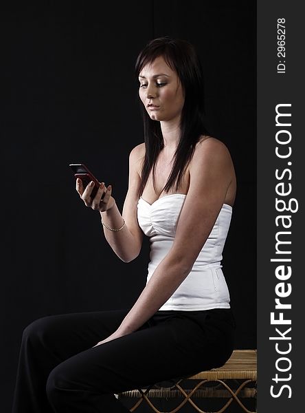 Attractive young woman calling by cellular phone. Attractive young woman calling by cellular phone