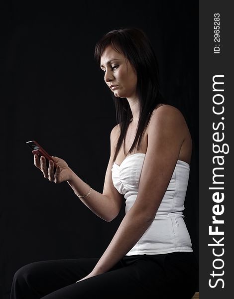 Attractive young woman calling by cellular phone. Attractive young woman calling by cellular phone