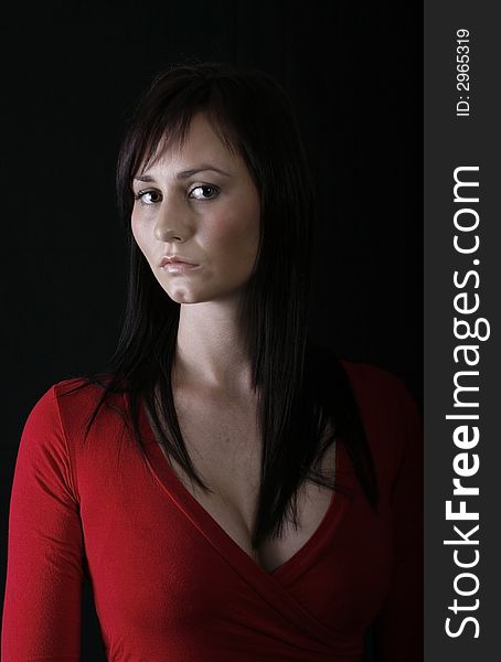 Pretty girl in red top, black background