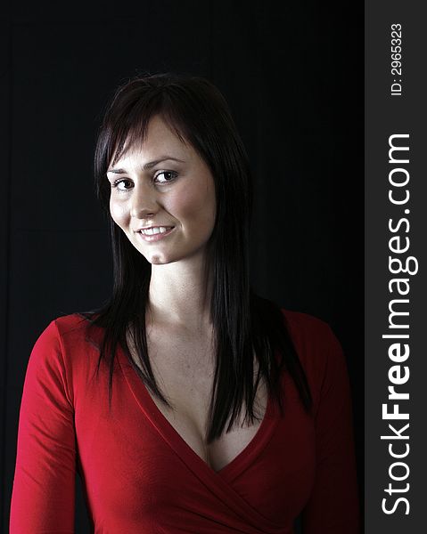 Pretty girl in red top, black background