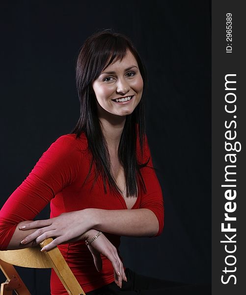 Pretty girl in red top, black background