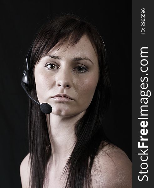Customer service agent wearing wireless headset, on the phone